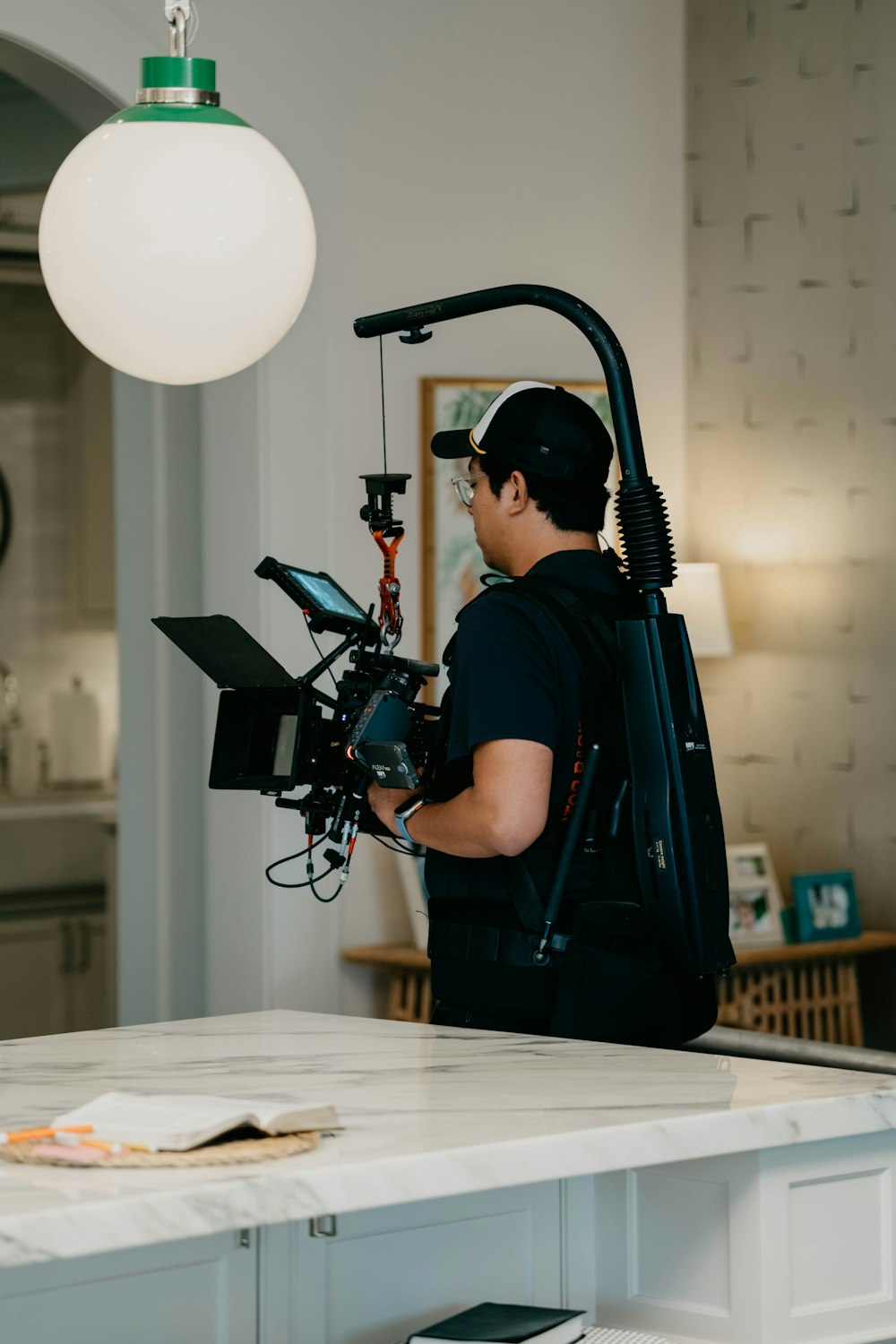 a man standing in a kitchen with a camera