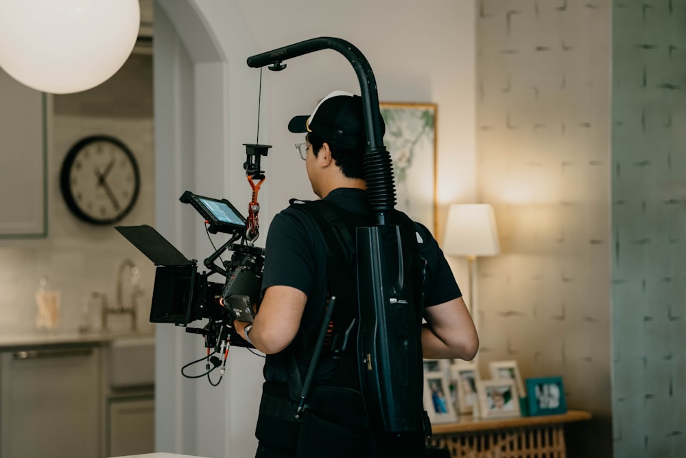 a man in a black shirt is holding a camera