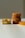 Several slices of cake are arranged on a white surface. On the left, two pieces are stacked with the cake's soft, fluffy interior visible. Toward the right, a stack of four round cakes is neatly aligned, showing their golden-brown crusts.