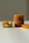 Several slices of cake are arranged on a white surface. On the left, two pieces are stacked with the cake's soft, fluffy interior visible. Toward the right, a stack of four round cakes is neatly aligned, showing their golden-brown crusts.