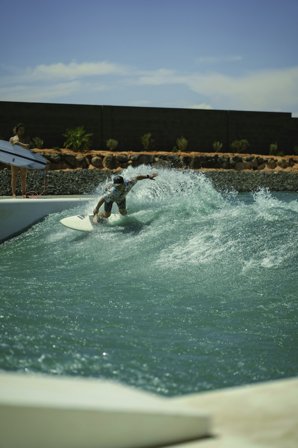 a man riding a wave on top of a surfboard