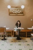 a woman sitting at a table in a restaurant