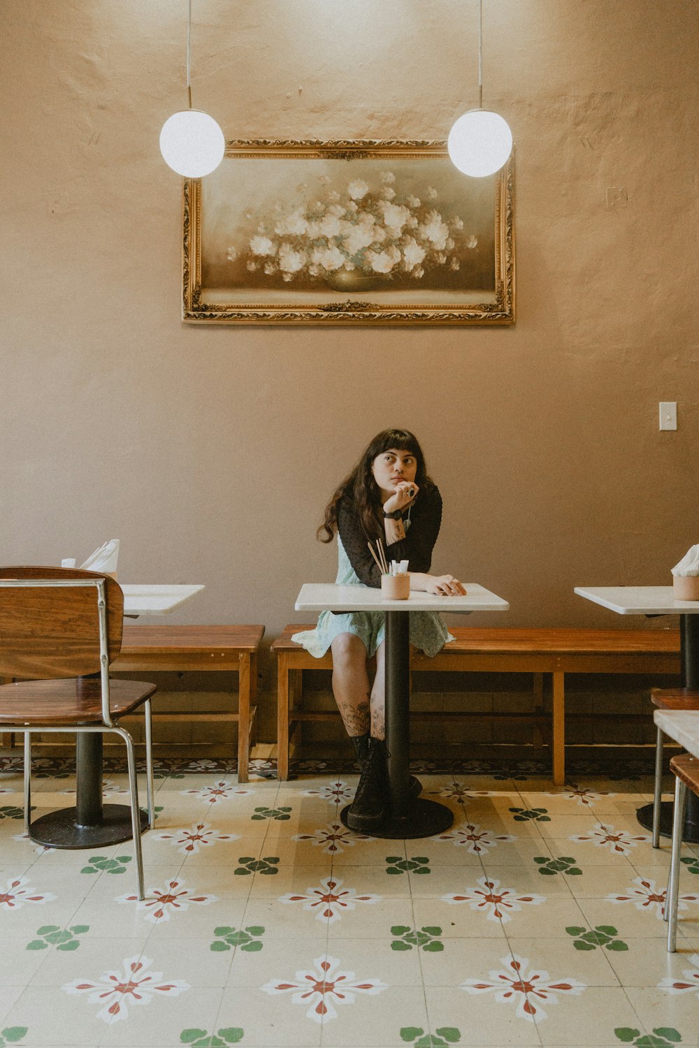 a woman sitting at a table in a restaurant
