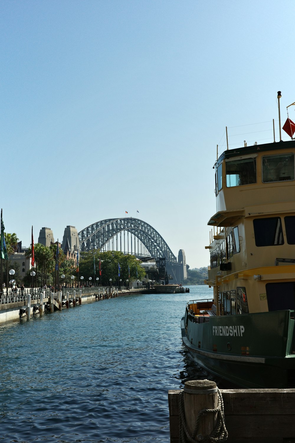 a boat is docked in the water near a bridge