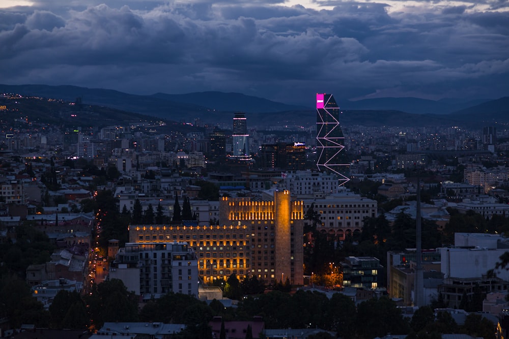 a view of a city at night from a hill