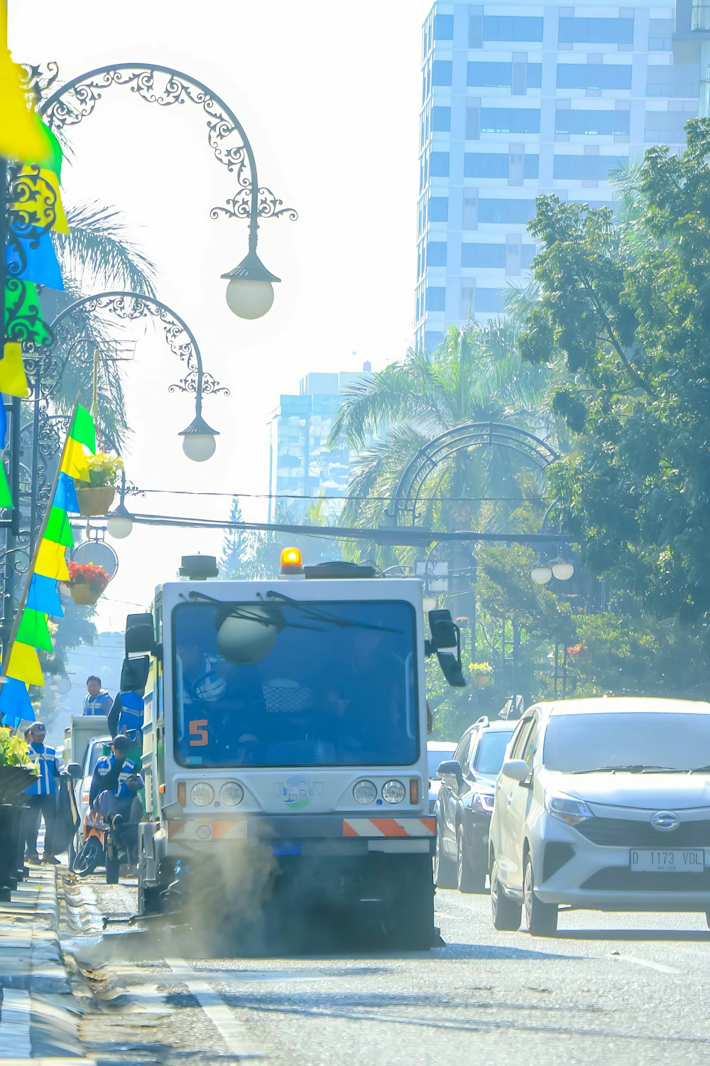 a truck driving down a street next to tall buildings