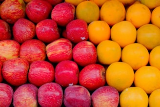 a pile of apples and oranges sitting next to each other