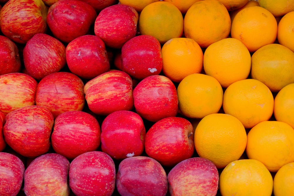 a pile of apples and oranges sitting next to each other