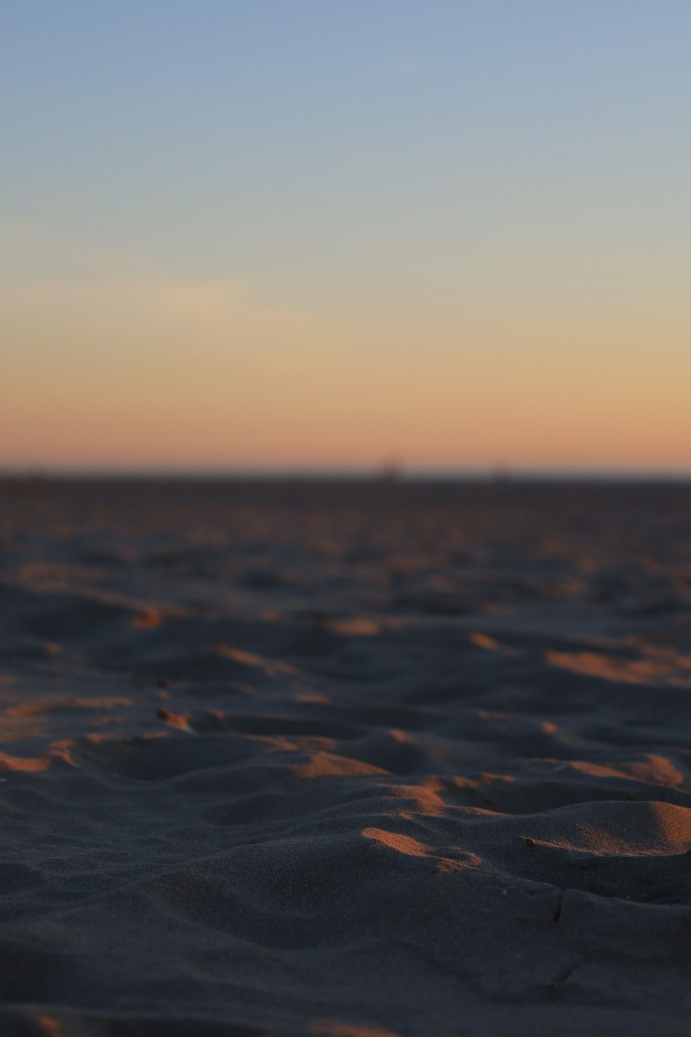 a blurry photo of a beach at sunset