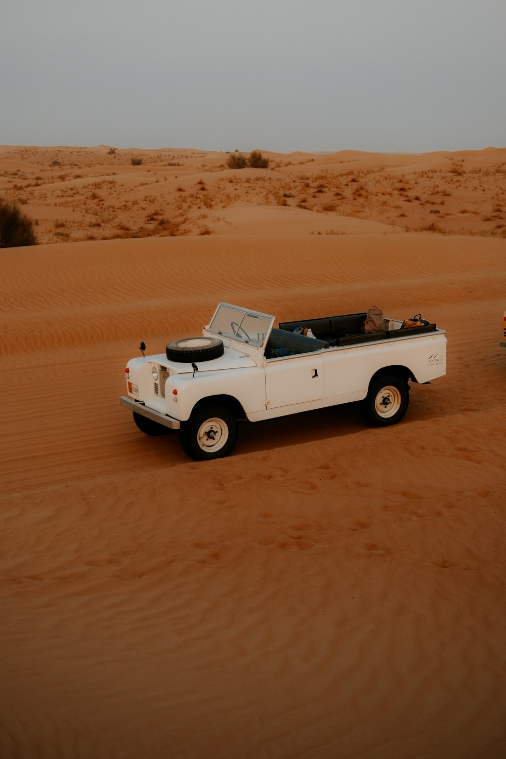 a white car in the middle of a desert