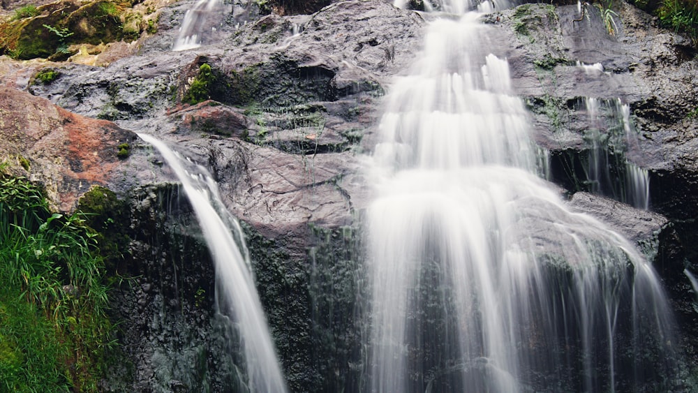 a group of people standing on top of a waterfall