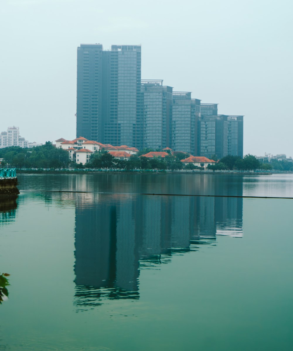 a body of water with buildings in the background