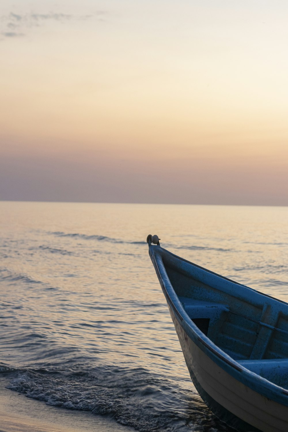 a small boat sitting on top of a beach