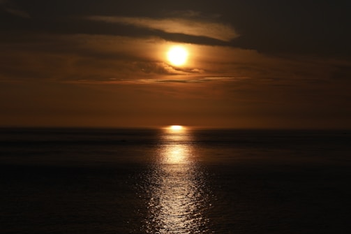 A vibrant sunset over a calm sea, reflecting the beauty of renewal.