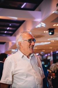 a man in a white shirt is smiling