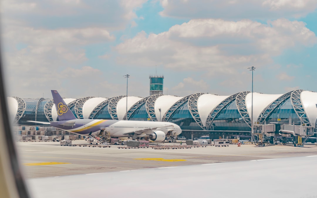 a large jetliner sitting on top of an airport tarmac Via Unsplash (by Kylle Pangan)