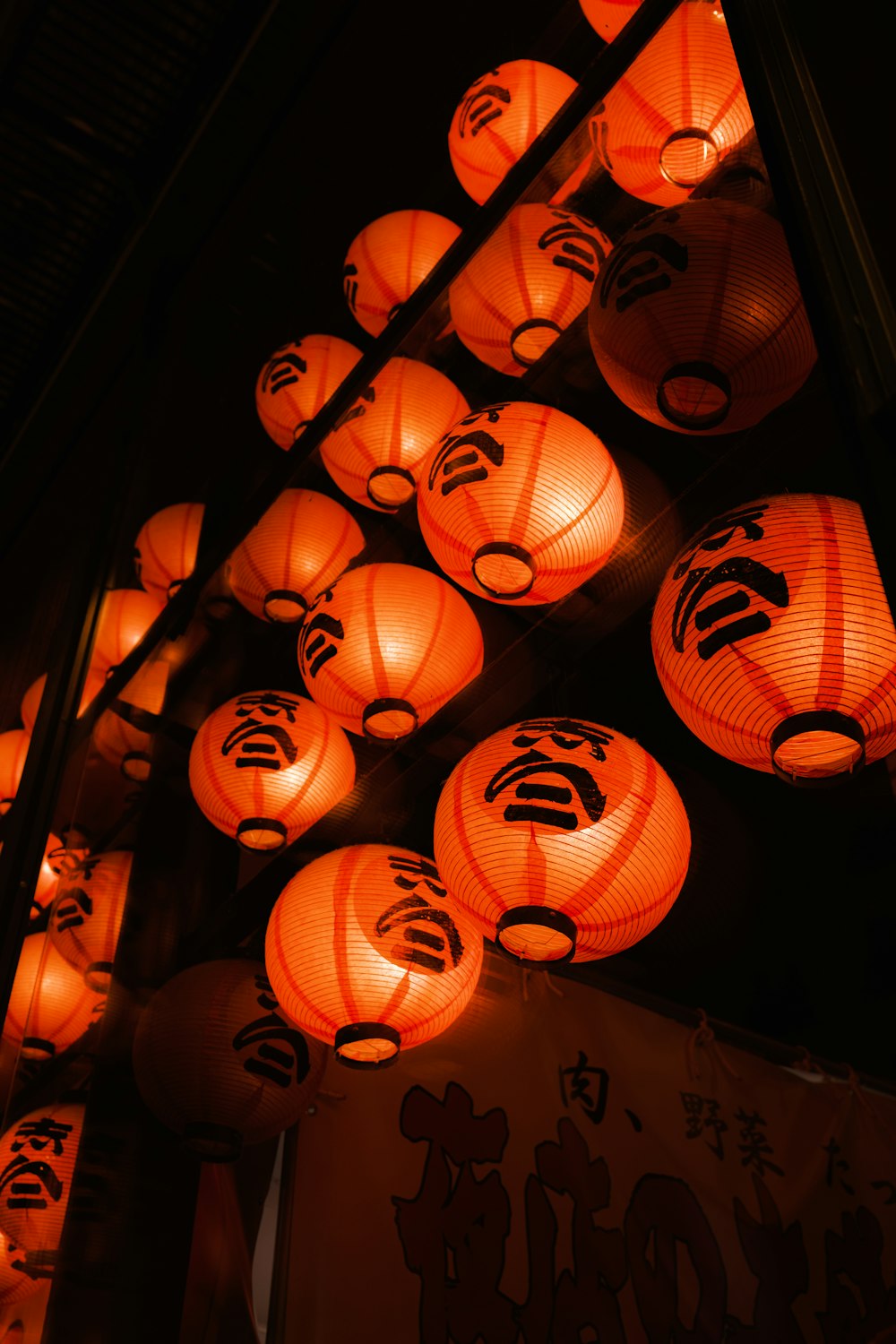 a bunch of lanterns that are lit up in the dark