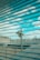 A surveillance camera is mounted on a pole overlooking a rooftop area. The scene is viewed through a set of horizontal blinds, creating a striped pattern across the image. The sky is visible in the background with scattered clouds.
