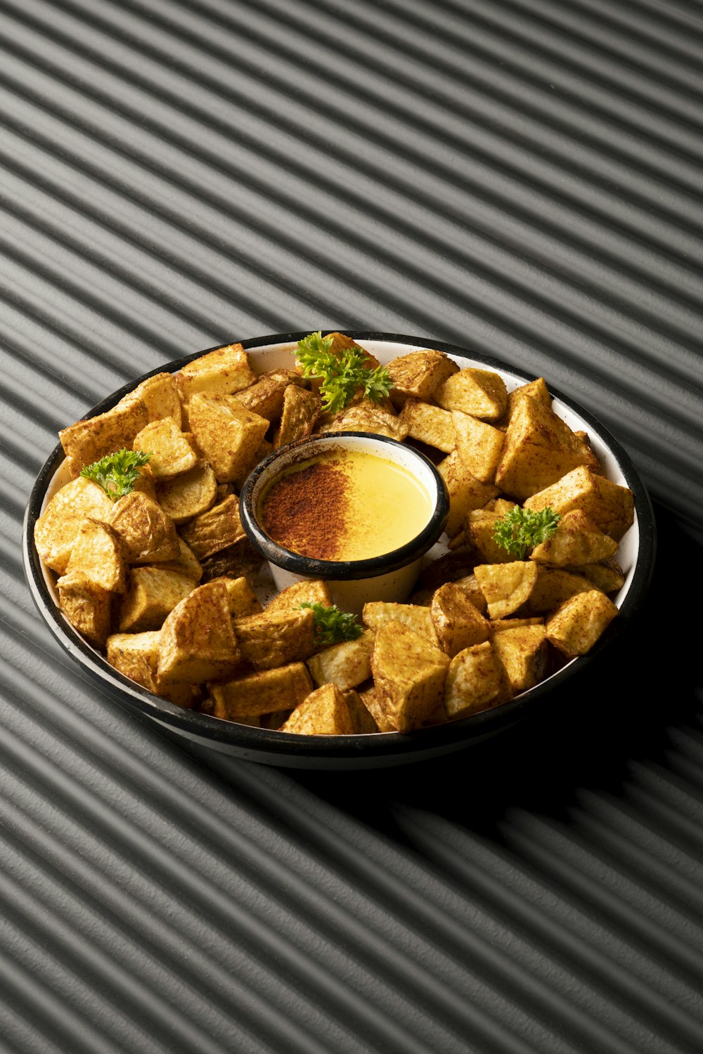 a plate of tofu with a dipping sauce