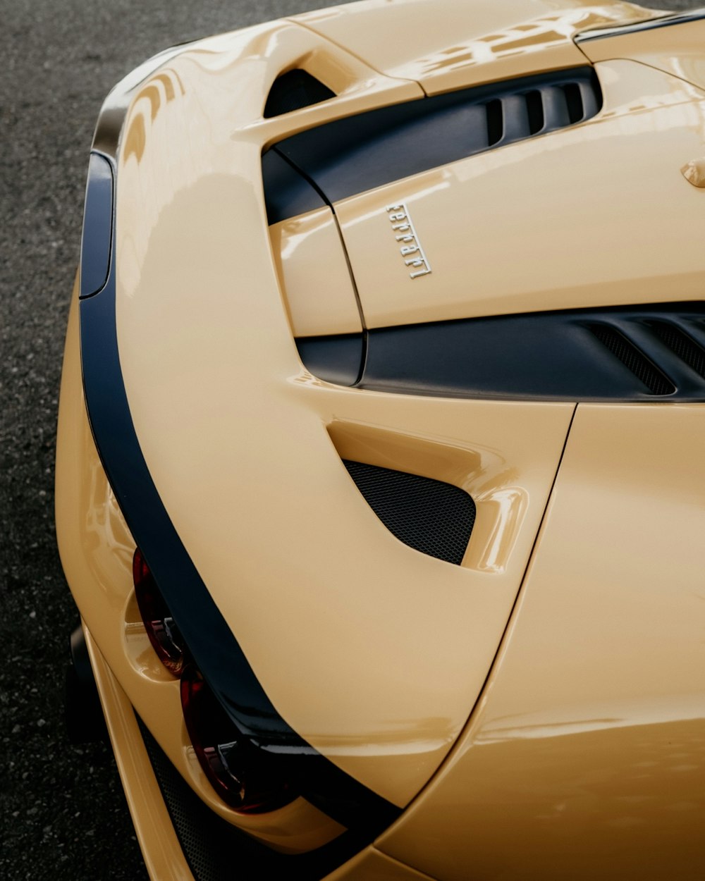 the rear end of a yellow sports car