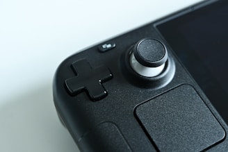A close-up of a portable gaming console on a wooden table.