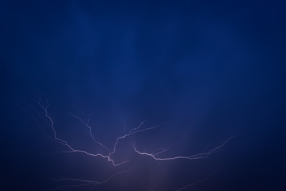 a dark blue sky with a lightning bolt
