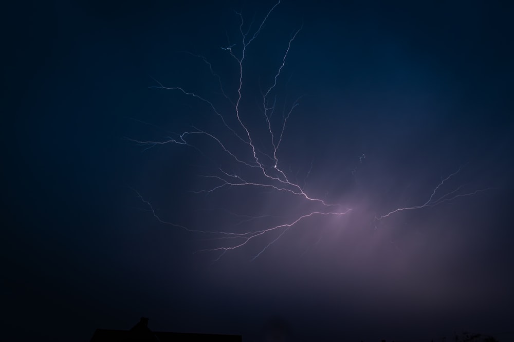 a lightning bolt is seen in the night sky