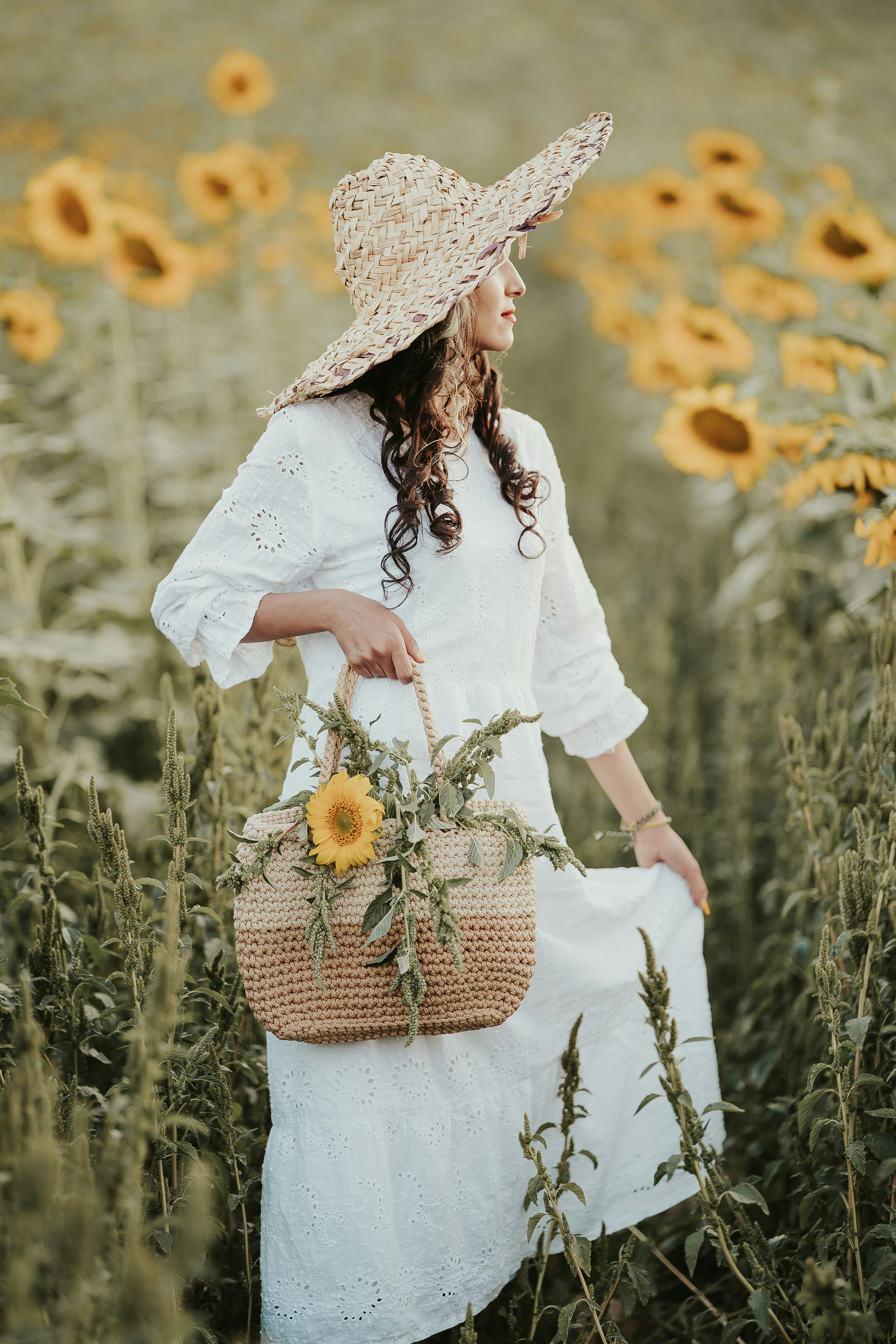 a woman standing in a field of sunflowers
