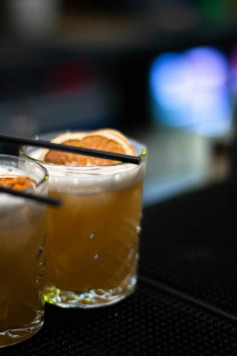 a couple of glasses filled with drinks on top of a table