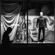 Black and white shot of a cuts storefront window display featuring the latest collection.