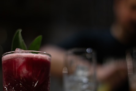 a close up of a drink in a glass on a table