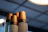 Close-up of kraft paper coffee cups stacked neatly on a wooden table.