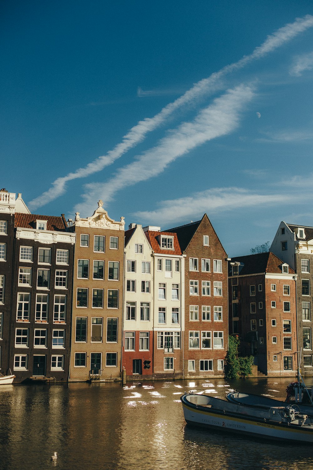 a row of buildings next to a body of water