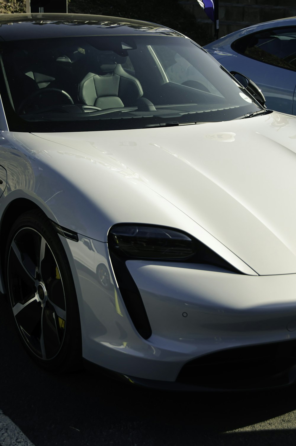 a white sports car parked in a parking lot