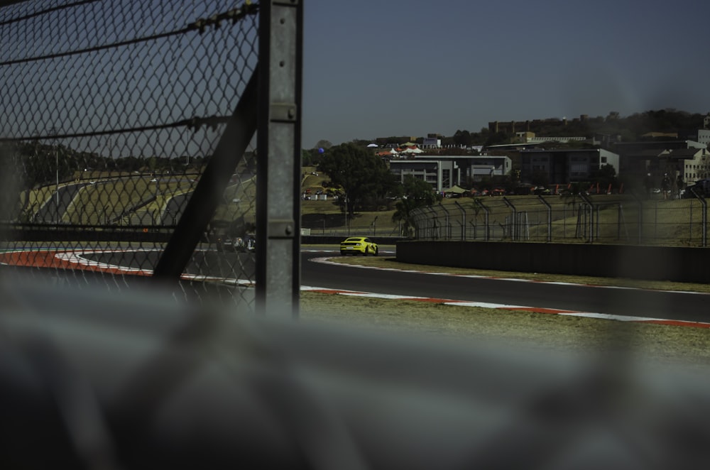 a view of a race track from behind a fence