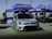 A silver Volkswagen car is prominently displayed in front of a blue tent with a Goodyear logo. The setup appears to be part of an outdoor automotive event, with spare tires neatly stacked to the side. Promotional banners and additional signage for Tyremart are visible around the area, and there are other cars in the background.