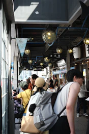 A joyful group of travelers exploring a vibrant market bathed in warm golden light.