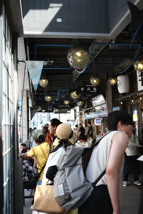A group of happy travelers exploring a vibrant local market on a scenic road trip.