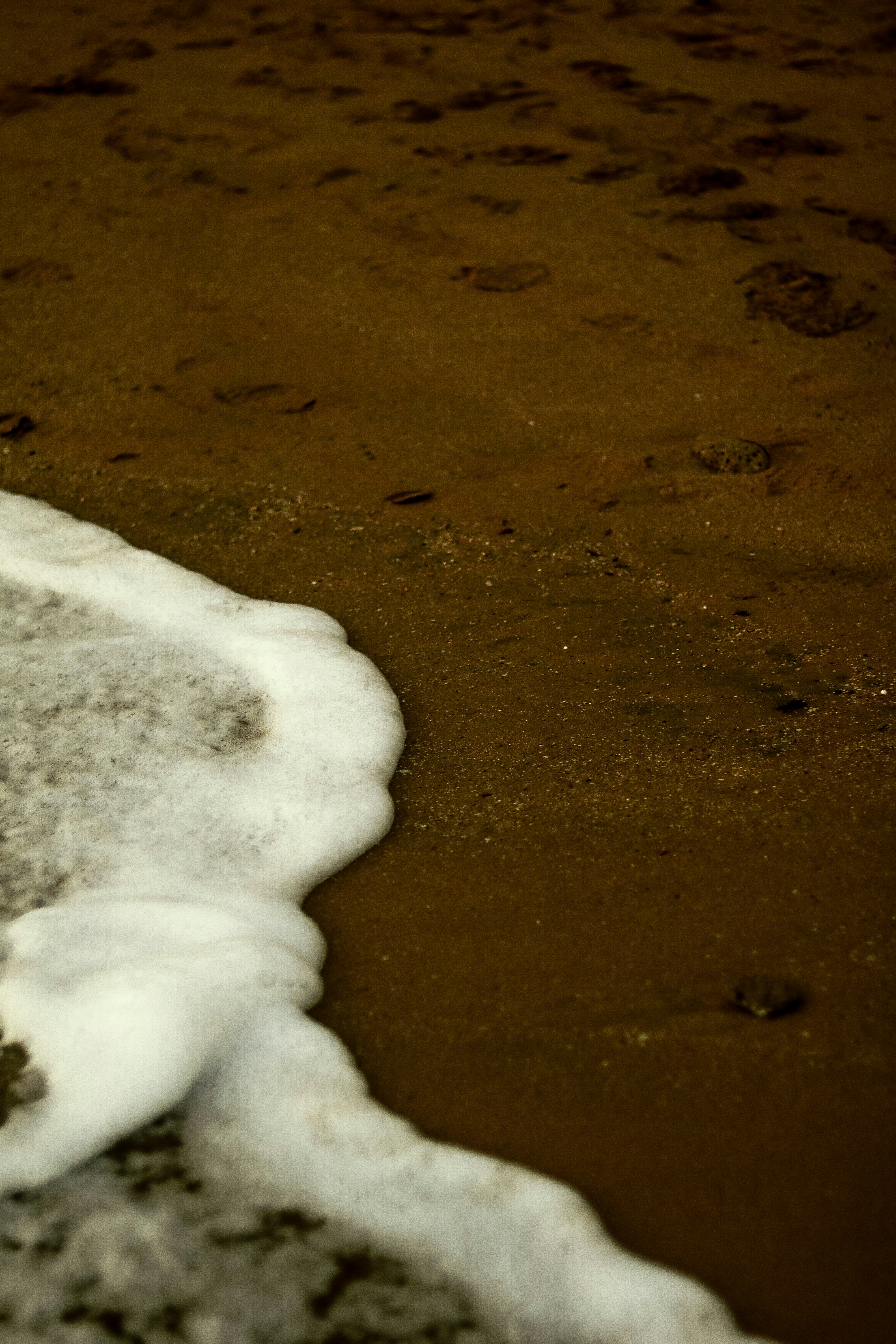 a surfboard sitting on top of a sandy beach