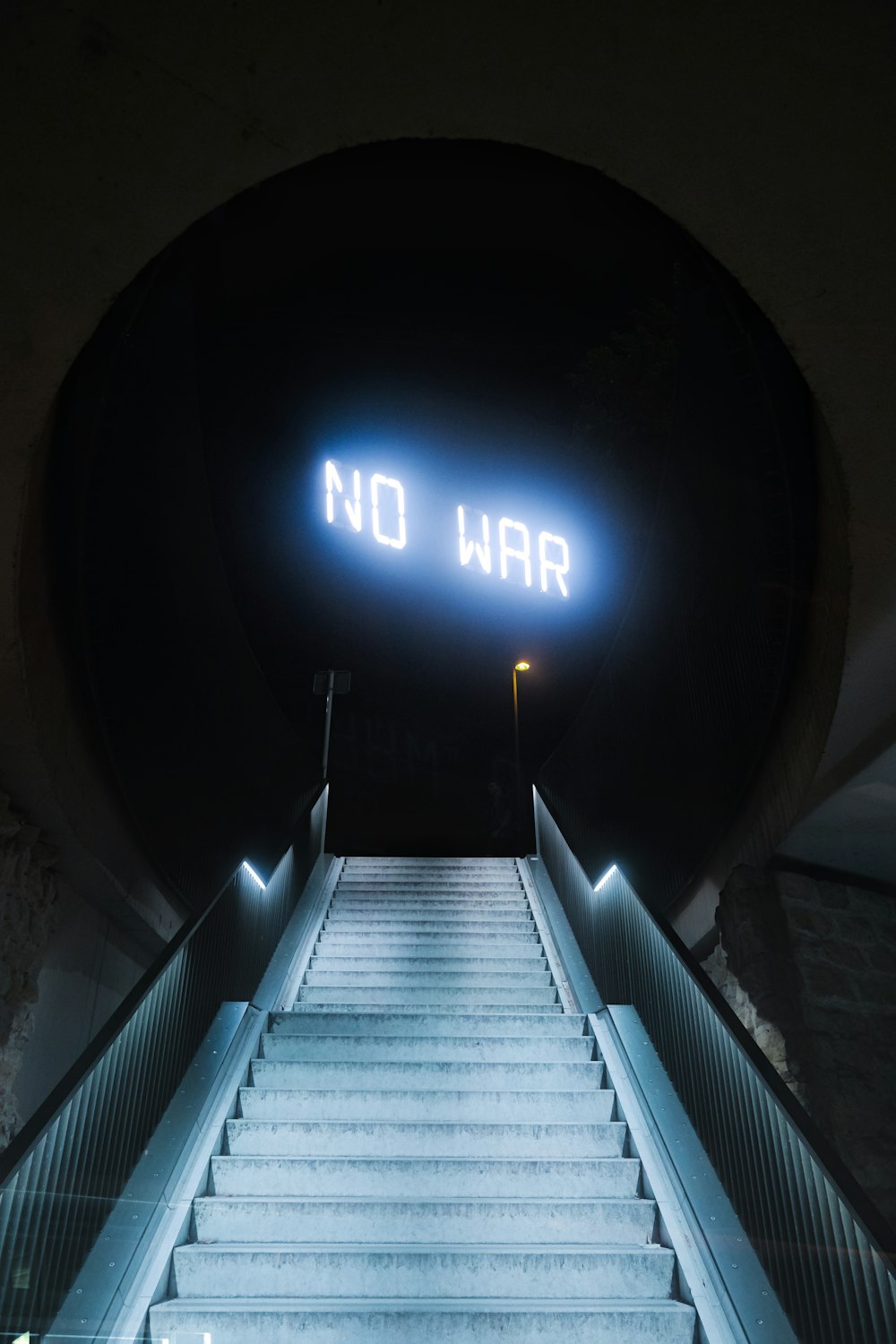 a set of stairs leading up to a sign that says no war