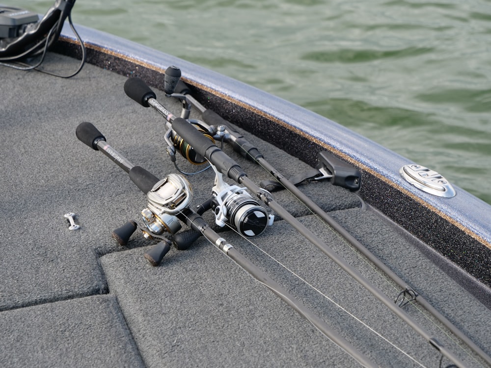 fishing rods and reels on a boat in the water