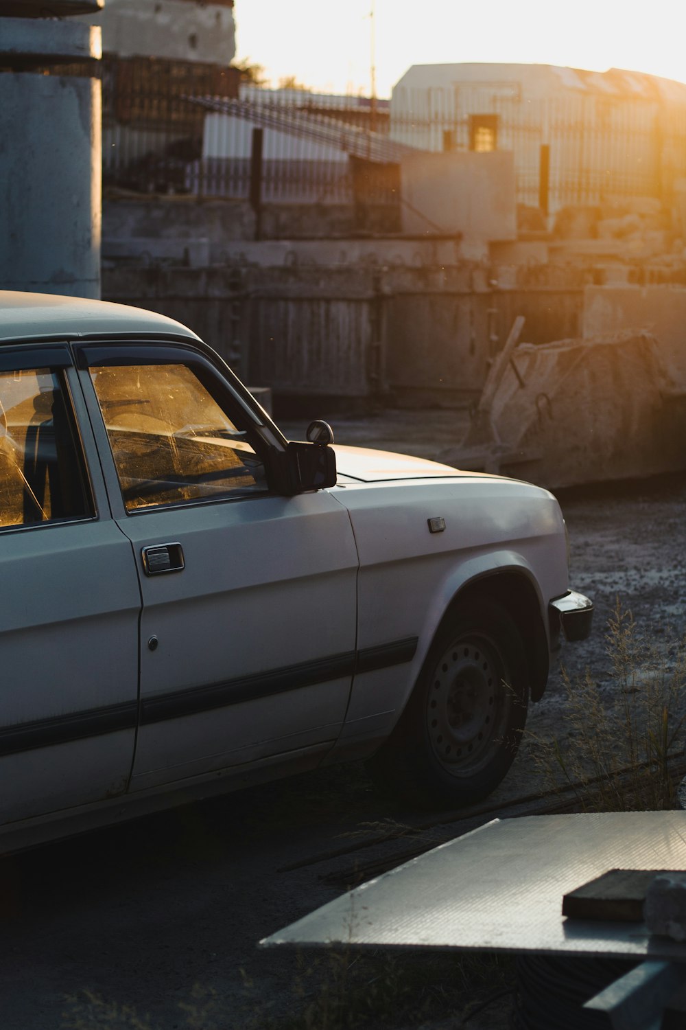 a white car parked on the side of a road