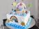 Close-up of a birthday cake topped with vibrant edible images of cartoon characters.