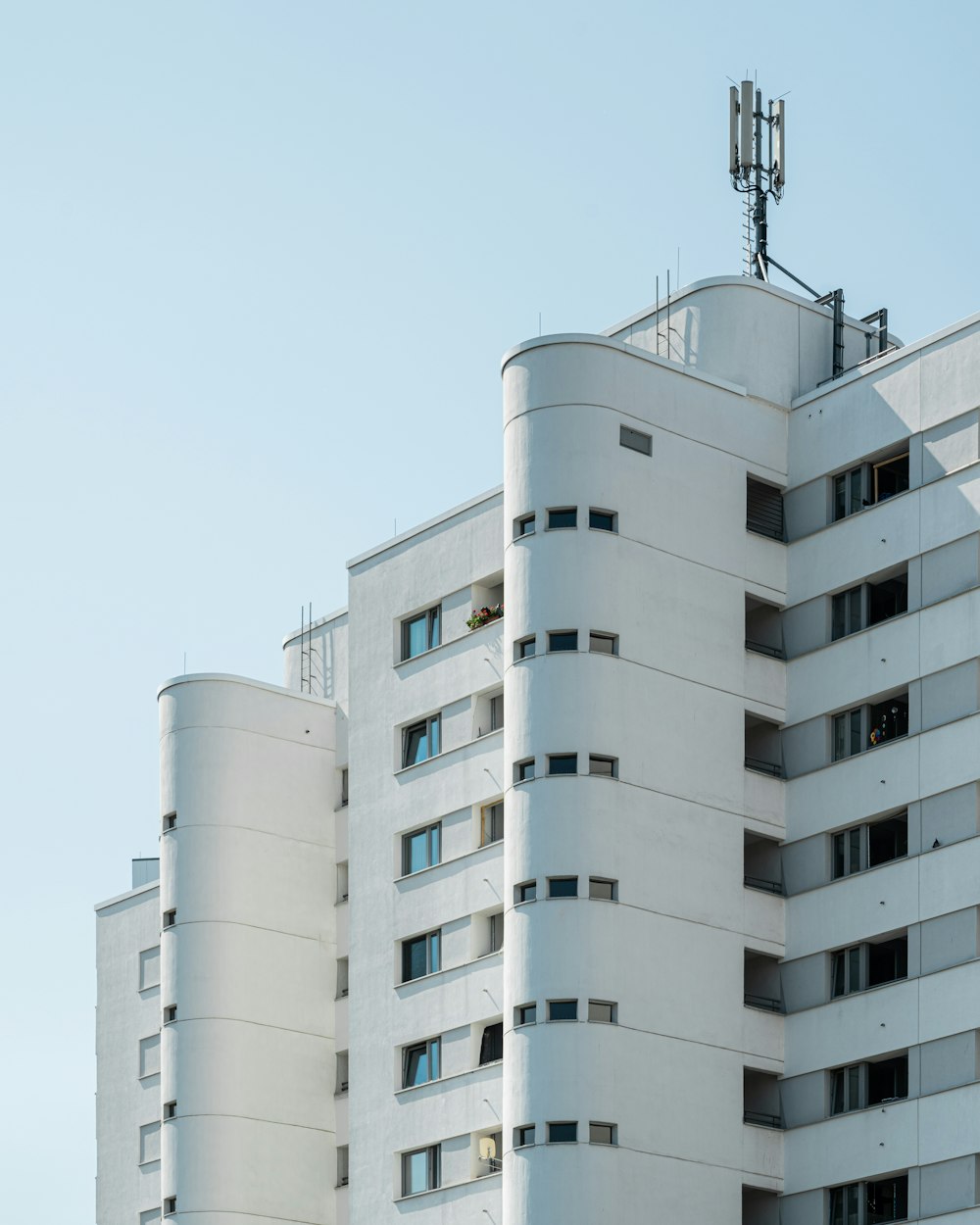 a tall white building with a clock on the top of it