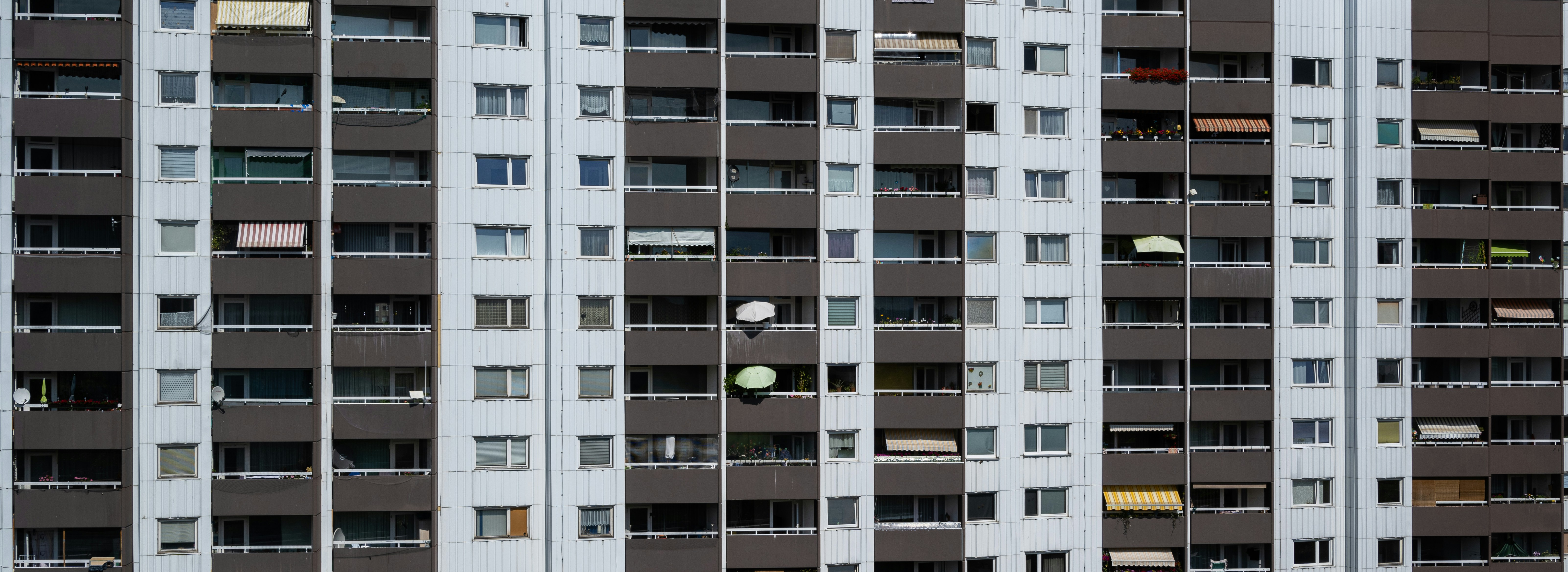 a tall building with lots of windows and balconies