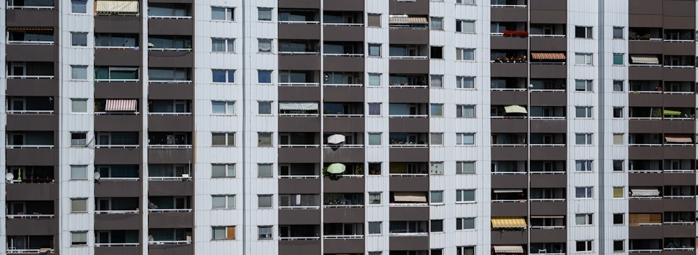 a tall building with lots of windows and balconies