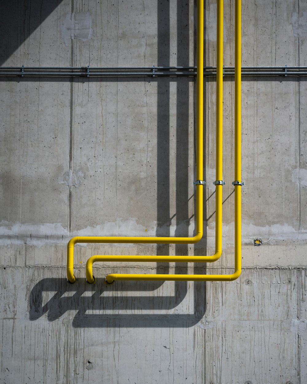 a yellow pipe on the side of a building