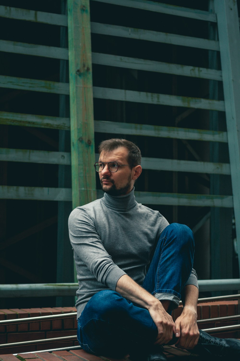 a man sitting on top of a wooden bench