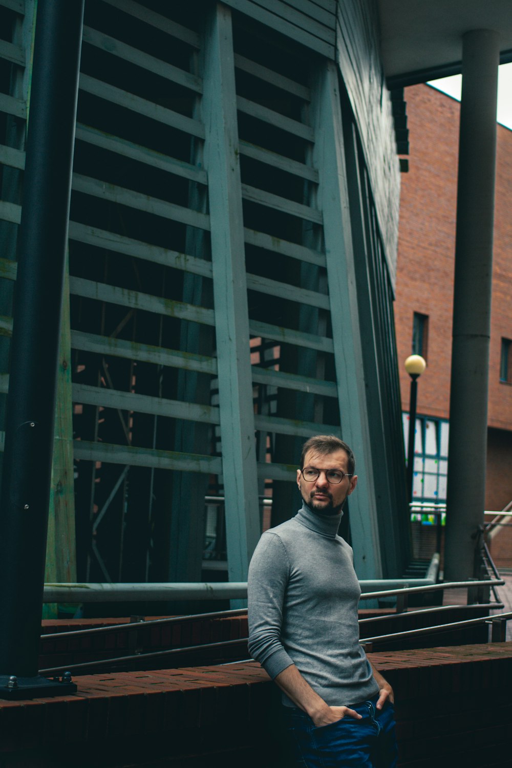 a man standing in front of a tall building