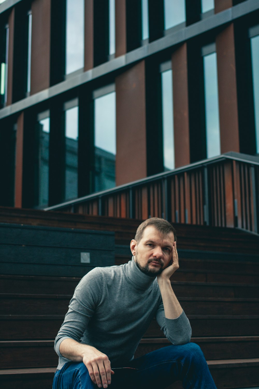 a man sitting on steps in front of a building